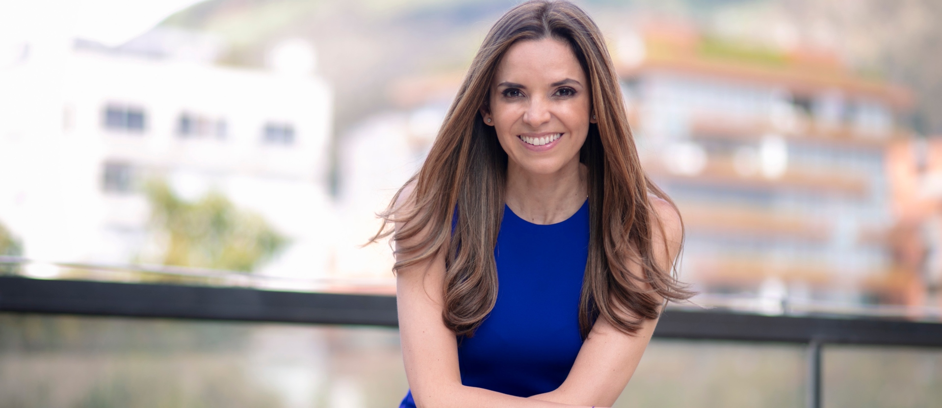 Catalina Bretón, gerente general de Nu Colombia, posa en un balcón con la ciudad de Bogotá detrás.